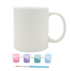 a white coffee mug with five different colored cups next to it and a pencil on the side