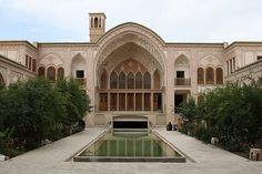 a large building with a fountain in front of it