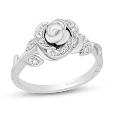 a white gold rose ring with diamonds on it