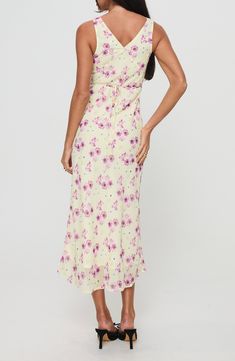 A dreamy floral print covers this slinky dress cut in a sleeveless silhouette and cinched at the waist by a back tie accent. 51" length Hidden side-zip closure V-neck Sleeveless Attached waist tie Lined 100% polyester Machine wash, tumble dry Imported Sleeveless Ruched Back Maxi Dress For Brunch, Sleeveless Maxi Dress With Ruched Back For Brunch, Sleeveless Fitted Floral Dress With Tie Back, Fitted Sleeveless Floral Dress With Tie Back, Fitted Floral Sleeveless Dress For Brunch, Floral Sleeveless Tie Back Dress For Brunch, Fitted Sleeveless Floral Dress With Smocked Back, Chic Sleeveless Floral Dress With Tie Back, Spring Sleeveless Maxi Dress With Ruched Back