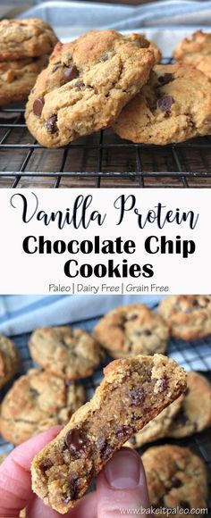 a hand holding up a chocolate chip cookie in front of some cookies on a cooling rack