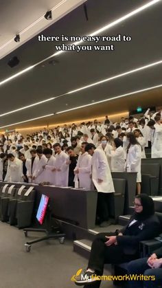 a large group of people in white lab coats