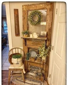 a room with a chair, potted plants and a mirror on top of it