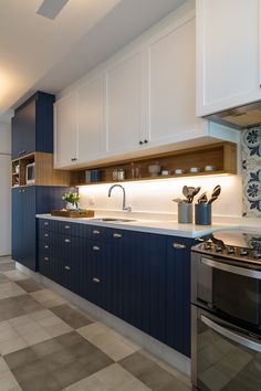 a kitchen with blue cabinets and white counter tops is featured on instagram for decorating