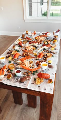 a long table covered in lots of different types of food on top of paper towels