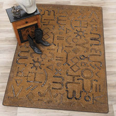 a pair of boots are sitting on a door mat that has letters and numbers written in it