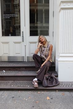 a woman sitting on steps talking on her cell phone