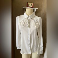 Menghui Fashion Crystal Jewelry Rhinestone Lapel Button Down Shirt White Blouse Women’s Size S. Tag L, But Fits Size S. Brand New With Original Tag. Price Is Firm. Nice For Holiday Pictures. Nice Shape . Measurements (Approximate While Lying Flat - See Attached Photos). Please Double Check The Measurements As There Are No Returns. No Holds. Smoke Free Home. Please See My Pictures For Details As They Are Part Of My Description. Thank You For Looking. Elegant Embellished Workwear Shirt, Embellished Fitted Shirt For Workwear, Embellished Button-up Workwear Blouse, Elegant Button-up Embellished Blouse, Elegant Embellished Button-up Blouse, Embellished Long Sleeve Shirt For Formal Occasions, Elegant Embellished Tops For Workwear, Elegant Embellished Spring Shirt, Elegant Long Sleeve Shirt With Embellished Collar