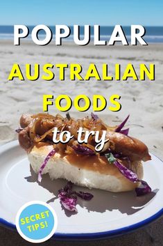 a white plate topped with food on top of a sandy beach