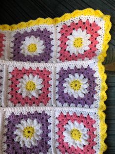 a crocheted blanket with flowers on it