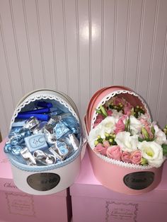 two pink boxes filled with different types of items