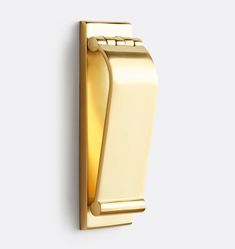 a gold door handle on a white wall