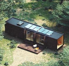 an aerial view of a tiny cabin in the woods