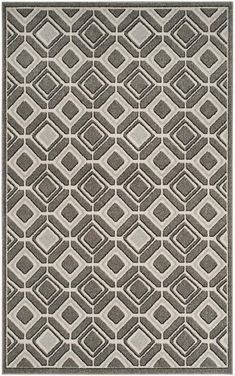 a gray and white rug with an abstract design