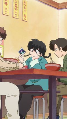 three people sitting at a table eating food