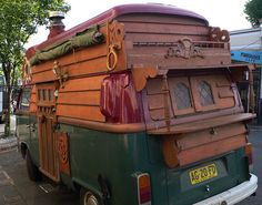 an old fashioned truck is parked on the side of the road