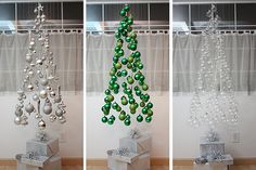 three christmas trees with ornaments hanging from them and one is made out of glass balls