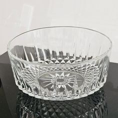 a glass bowl sitting on top of a black table