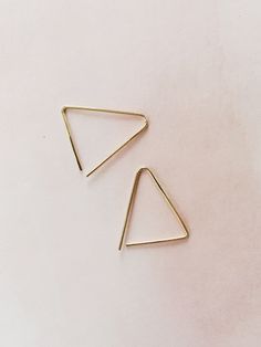 The sweetest 14k gold fill triangle shaped earrings are lightly hammered which gives them extra shine. Earrings measure 1" x .75". Gold Triangle Minimalist Earrings, Minimalist Gold Triangle Earrings, Everyday Gold Triangle Earrings, Everyday Triangle Nickel-free Jewelry, Nickel-free Gold Triangle Jewelry, Everyday Nickel-free Triangle Jewelry, Gold Triangle Jewelry With Ear Wire, Minimalist Triangle Nickel-free Earrings, Minimalist Nickel-free Triangle Earrings