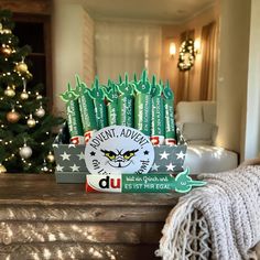 an assortment of green toothpaste on a table in front of a christmas tree