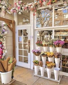 a flower shop with lots of flowers in the window