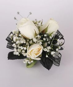 a bouquet of white roses and baby's breath