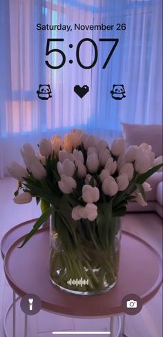 a vase filled with white flowers on top of a table