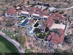 an aerial view of a mansion in the desert