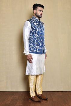 Blue bundi with contrasting floral pattern embroidered front. Comes with white kurta and golden pant. - Aza Fashions Spring Festive Bandhgala With Gota Work, Traditional Bandhgala With Gota Work For Spring, Traditional Spring Bandhgala With Gota Work, Traditional Blue Sherwani For Spring, Blue Sherwani For Spring Festive Occasions, Blue Sherwani For Spring Festivities, Blue Sherwani For Festive Spring Occasions, Spring Blue Traditional Sherwani, Blue Traditional Sherwani For Spring