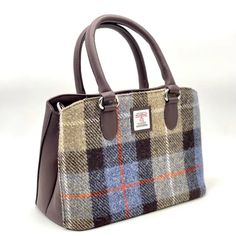 Harris Tweed Top Handle Bag Crafted from Genuine Harris Tweed with a vegan leather trim, this Top Handle Handbag is defined by its structured silhouette and generous space inside. The sturdy top handles are sized to fit comfortably in the crook of your arm, while a crossbody strap delivers easy and stylish hands-free wear. Inside this tweed handbag are two large compartments with a secure zip pocket on one side and 2 smaller open pockets on the other. The Harris Tweed bag is finished off with a Harris Tweed Bag, Tweed Purse, Tweed Handbag, Tweed Bag, Tweed Top, Mini Messenger Bag, Herringbone Tweed, Purple Plaid, Top Handle Handbags