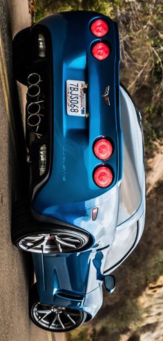 the rear end of a blue sports car