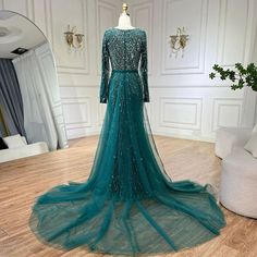 Exquisite mermaid silhouette gown with an elegant green overskirt, perfect for weddings and formal events. Crafted with meticulous attention to detail and high-quality materials for a luxurious feel. Features intricate beadwork that adds a touch of opulence and glamour. Inspired by Dubai luxury fashion, designed to exude elegance and sophistication. Ideal attire for Muslim women attending weddings, parties, or formal events. Flattering fit that accentuates curves while providing comfort and ease Dubai Gowns, Beaded Mermaid, Long Evening Dresses, Dubai Luxury, Mermaid Silhouette, Mermaid Evening Dresses, Evening Dresses Long, Formal Evening Dresses, Muslim Women