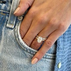 a close up of a person's hand with a ring on their finger