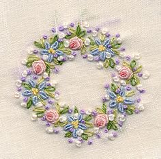 an embroidered wreath with flowers on it