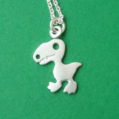 Tiny Dinosaur Necklace Halloween Necklace in Sterling Silver. $28.00, via Etsy. Silver Novelty Necklaces With Charms, Novelty Silver Necklaces With Charms, Nickel-free Novelty Pendant Necklaces, Nickel-free Novelty Pendant Necklace, Novelty Nickel-free Pendant Necklace, Novelty Dinosaur Print Jewelry Gift, Novelty Sterling Silver Charm Jewelry, Novelty Sterling Silver Jewelry With Charms, Sterling Silver Novelty Necklace For Gift