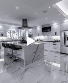 a kitchen with marble floors and white cabinets