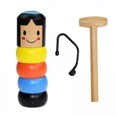 a stacking toy with a wooden mallet next to it and a rubber stick