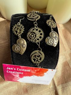 This unique bracelet and earrings set is handmade with gears.  The bracelet is 7.5 - 8 inches, and the earrings are 2" long. Gear Earrings, Flower Bowl, Small Christmas Trees, Jewellery Sets, Unique Bracelets, Brass Jewelry, Earrings Set, Earring Set, Jewelry Sets