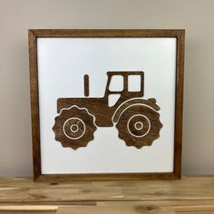 a wooden frame with a tractor cut out on it