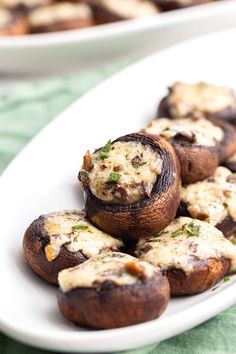 mushrooms stuffed with cheese and herbs on a white plate