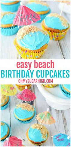 cupcakes with blue frosting and an umbrella on top are sitting on a white table