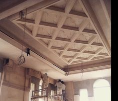 a man is working on the ceiling in an old building