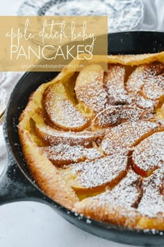 apple dutch baby pancakes in a cast iron skillet with powdered sugar on top