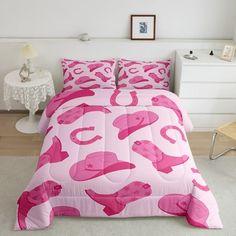 a bed with pink flamingos on it in a white room