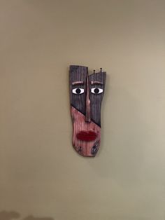 a wooden mask hanging on the wall