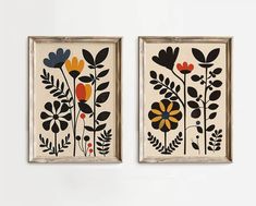 two framed art pieces with flowers and leaves on them