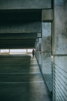 the person is walking under an overpass