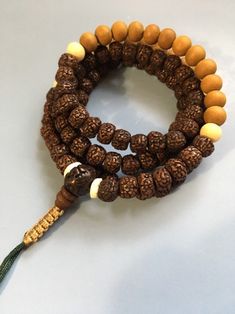 Old Rudraksha Mala Necklace with Sandalwood and Bone. Laid out iin a Zen sequence with an adjustable knot. Great for meditation mindfulness Adjustable Mala With 8mm Beads For Festivals, Adjustable Spiritual Mala For Festivals, Adjustable Hand Wrapped Mala For Healing, Adjustable 8mm Beads Mala For Festival, Adjustable Brown Mala For Healing, Adjustable Brown Mala For Festival, Handmade Adjustable Mala For Festivals, Adjustable Brown Mala For Rituals, Adjustable Brown Holistic Necklaces