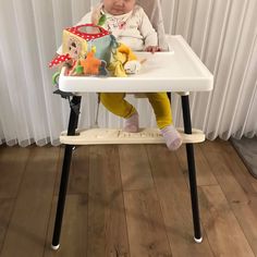 a small child sitting in a high chair