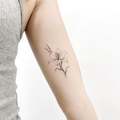 a woman's arm with a flower tattoo on the left side of her arm